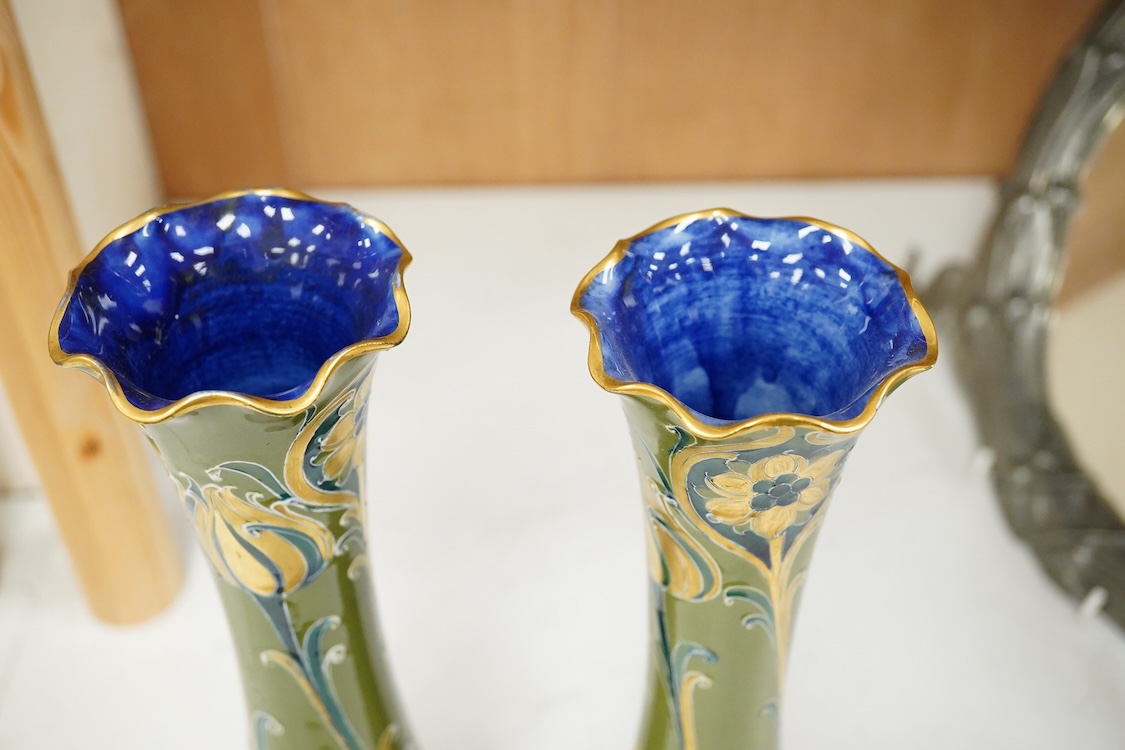 A pair of early 20th century Moorcroft MacIntrye Florian green and gold vases, signed and stamped to the bases, 29cm high